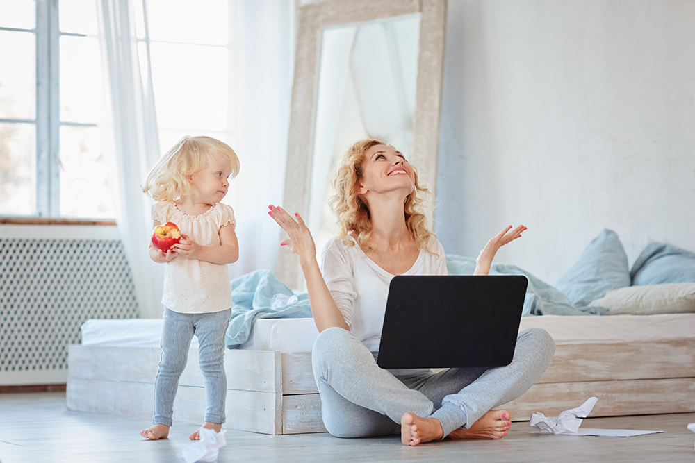 An,Inspired,Woman,Sits,On,The,Floor,With,A,Laptop