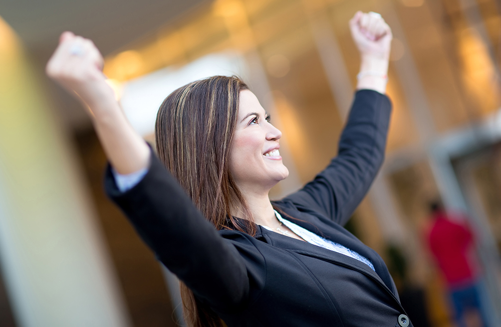 Successful,Business,Woman,With,Arms,Up,Celebrating